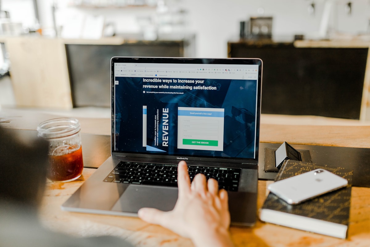 Digital marketing professional reviewing paid media and PPC campaign performance on a MacBook